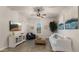 Living room with tile floors, white sofa, ceiling fan, and decor at 17850 E Bronco Ct, Queen Creek, AZ 85142