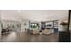 Open-concept living and dining area boasts abundant natural light, neutral decor, and an open floor plan at 17850 E Bronco Ct, Queen Creek, AZ 85142
