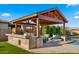 Impressive outdoor kitchen and entertainment area, perfect for hosting gatherings by the pool at 17850 E Bronco Ct, Queen Creek, AZ 85142