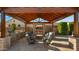 Cozy outdoor living space with brick fireplace, grill, and comfortable seating for stylish relaxation and entertaining at 17850 E Bronco Ct, Queen Creek, AZ 85142