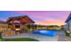 Gorgeous outdoor living space with pool view, outdoor dining and outdoor kitchen at 17850 E Bronco Ct, Queen Creek, AZ 85142