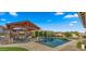 Stunning backyard featuring a sparkling pool, outdoor kitchen, and beautifully landscaped entertainment area at 17850 E Bronco Ct, Queen Creek, AZ 85142