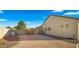 Side yard with gravel, a secure gate, and the house exterior, providing utility and privacy at 17850 E Bronco Ct, Queen Creek, AZ 85142
