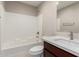 Bathroom featuring vanity with solid surface counter and a tiled shower-tub combo at 2000 N 36Th St # 19, Phoenix, AZ 85008