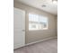 Bedroom featuring plush carpet, paneled door, and view through window at 2000 N 36Th St # 19, Phoenix, AZ 85008