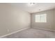 Bright bedroom featuring neutral walls, a window, and plush gray carpeting at 2000 N 36Th St # 19, Phoenix, AZ 85008