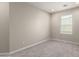 Neutral bedroom showcasing plush carpet and natural light from a bright window at 2000 N 36Th St # 19, Phoenix, AZ 85008