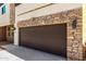 Townhome garage door with stone accents and tan stucco; Number 19 is displayed on the facade at 2000 N 36Th St # 19, Phoenix, AZ 85008