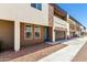 Exterior view of modern townhome featuring a brown garage door and beige siding at 2000 N 36Th St # 19, Phoenix, AZ 85008