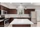 Stylish kitchen with stainless steel appliances, quartz countertops, and dark cabinetry at 2000 N 36Th St # 19, Phoenix, AZ 85008