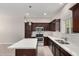 Modern kitchen features stainless steel appliances, quartz countertops, and an island with pendant lighting at 2000 N 36Th St # 19, Phoenix, AZ 85008
