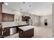 Bright kitchen featuring stainless steel appliances, island, and dark wood cabinets at 2000 N 36Th St # 19, Phoenix, AZ 85008