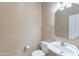 Half bathroom with a white toilet, sink, mirror, and neutral walls at 20277 N 68Th Dr, Glendale, AZ 85308