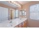 Bathroom featuring double sinks, a large mirror, and great lighting at 20277 N 68Th Dr, Glendale, AZ 85308