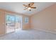 Bedroom with patio door, ceiling fan, and carpet floors at 20277 N 68Th Dr, Glendale, AZ 85308