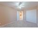 Bedroom featuring plush carpet, a ceiling fan, and a closet at 20277 N 68Th Dr, Glendale, AZ 85308