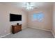 Bedroom featuring carpet floors, ceiling fan, and a window for natural light at 20277 N 68Th Dr, Glendale, AZ 85308