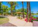 Picturesque community park with a covered picnic area, vibrant flowers, and a serene lake at 20277 N 68Th Dr, Glendale, AZ 85308