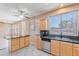 Well-lit kitchen area featuring granite countertops, wood cabinets, and stainless-steel appliances at 20277 N 68Th Dr, Glendale, AZ 85308