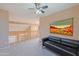 Bright loft area with a ceiling fan and a cozy black leather sofa at 20277 N 68Th Dr, Glendale, AZ 85308