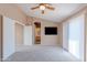 Spacious bedroom features neutral carpet, ceiling fan, and access to the ensuite bathroom at 20277 N 68Th Dr, Glendale, AZ 85308