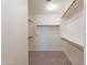 Walk-in closet features wood shelves and rack, with carpet flooring at 20277 N 68Th Dr, Glendale, AZ 85308