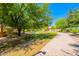 Community walking path surrounded by mature trees and green lawns, perfect for outdoor recreation at 20277 N 68Th Dr, Glendale, AZ 85308