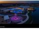 Stunning aerial view of a community pool, splash pad, and lake illuminated at night at 23068 E Stacey Rd, Queen Creek, AZ 85142