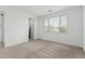 Bright, carpeted bedroom with a large window, closet and fresh paint at 23068 E Stacey Rd, Queen Creek, AZ 85142