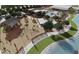 Rendering of community playground with slides, swings, and climbing structures by a lake at 23068 E Stacey Rd, Queen Creek, AZ 85142