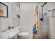 Bathroom with a modern vanity, commode, shower, and a sunflower shower curtain at 2319 N 71St Dr, Phoenix, AZ 85035