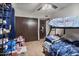 This shared bedroom is filled with toys and a bunk bed set, along with access to a closet and door at 2319 N 71St Dr, Phoenix, AZ 85035
