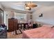 Bright bedroom with carpet, ceiling fan, and dresser providing a relaxing personal space at 2319 N 71St Dr, Phoenix, AZ 85035