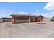 Charming single-story home showcasing a two-car garage, solar panels, and desert landscaping at 2319 N 71St Dr, Phoenix, AZ 85035