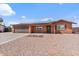 Charming single-story home featuring a two-car garage, desert landscaping, and a welcoming front porch at 2319 N 71St Dr, Phoenix, AZ 85035