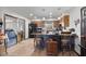 Spacious kitchen with an island, pendant lighting, and adjacent seating area at 2319 N 71St Dr, Phoenix, AZ 85035