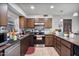 Functional kitchen with wood cabinetry, stainless steel appliances, and durable countertops at 2319 N 71St Dr, Phoenix, AZ 85035