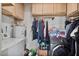 Functional laundry room featuring side-by-side washer and dryer and storage at 2319 N 71St Dr, Phoenix, AZ 85035