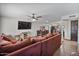 Open-concept living room with modern lighting, seamless flow to kitchen, and a large sectional sofa at 2319 N 71St Dr, Phoenix, AZ 85035