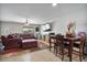 Open-concept living room with a cozy seating area and view into dining room at 2319 N 71St Dr, Phoenix, AZ 85035