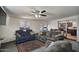 This living room features an open floor plan to the kitchen, a ceiling fan, and access to the backyard at 2319 N 71St Dr, Phoenix, AZ 85035