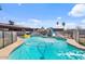 Sparkling backyard pool with slide, fun inflatables, and a secure safety fence perfect for Gathering enjoyment at 2319 N 71St Dr, Phoenix, AZ 85035