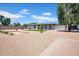 Large, landscaped backyard features gravel, turf, and mature trees providing ample shade at 2712 N 20Th Dr, Phoenix, AZ 85009