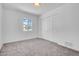 Bedroom featuring carpet floors, a closet, and a bright window at 2712 N 20Th Dr, Phoenix, AZ 85009