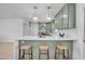 Spacious kitchen featuring a center island with bar stools and modern pendant lighting at 2712 N 20Th Dr, Phoenix, AZ 85009