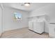 Well-lit laundry room with modern washer, dryer, storage shelf and utility sink at 2712 N 20Th Dr, Phoenix, AZ 85009