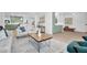 Open-concept living room with a comfortable couch, stylish rug, and view of the kitchen at 2712 N 20Th Dr, Phoenix, AZ 85009