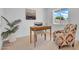 Bright office space with a wooden desk, patterned chair, rug, and ample natural light at 2712 N 20Th Dr, Phoenix, AZ 85009