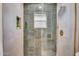 Modern shower with green tile and gold-colored fixtures at 2712 N 20Th Dr, Phoenix, AZ 85009