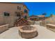 This backyard features a stone fire pit and dining area for outdoor enjoyment and relaxation at 3016 W White Canyon Rd, San Tan Valley, AZ 85144